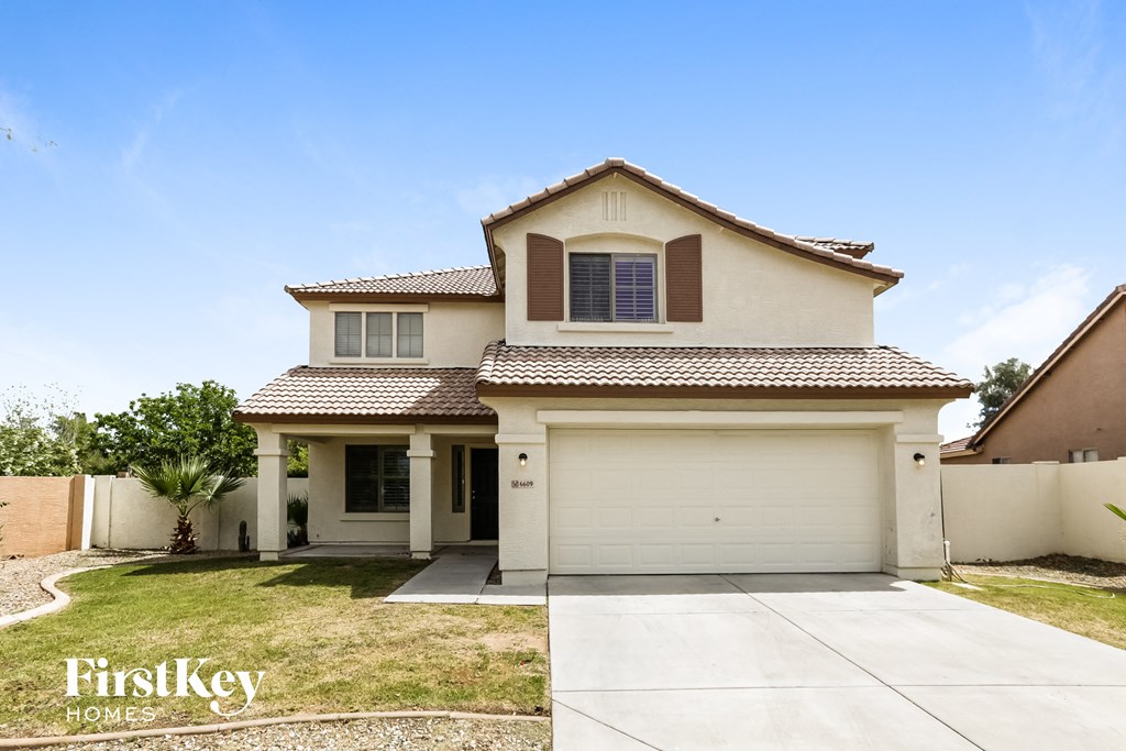 a house with a white garage door and a lawn