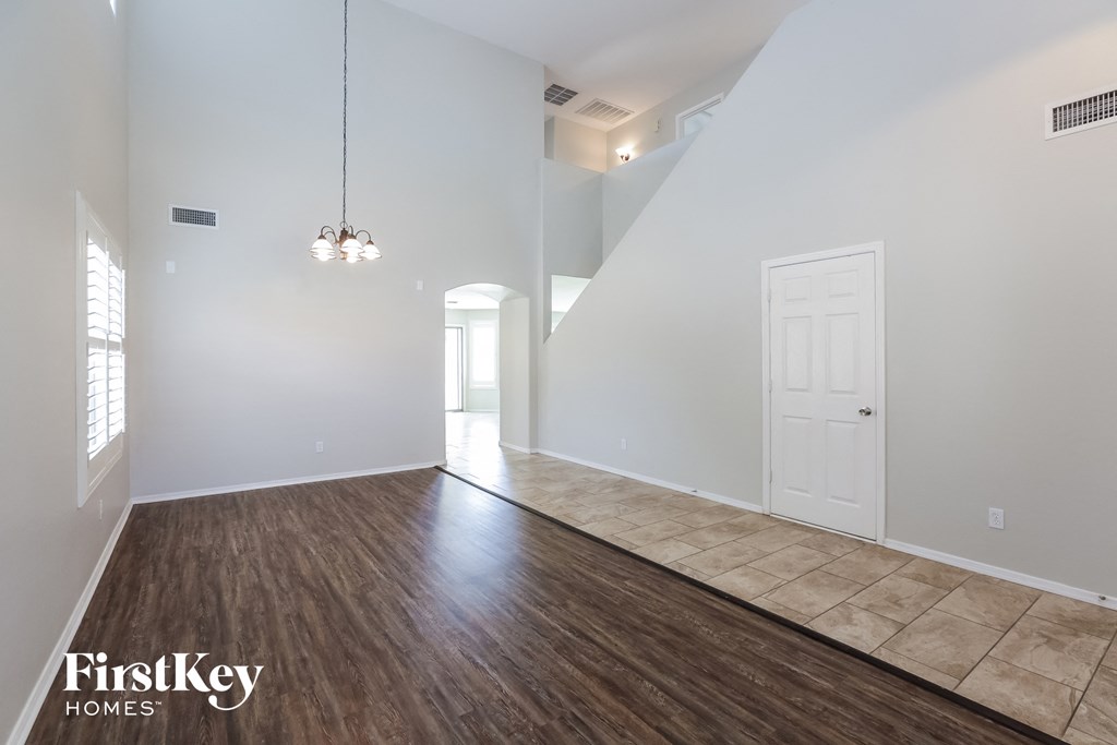 the living room and dining room with hardwood flooring and white walls