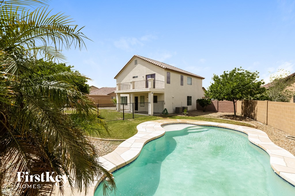 a backyard with a pool and a house