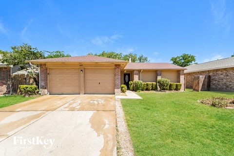A house with a brown garage door is for sale.