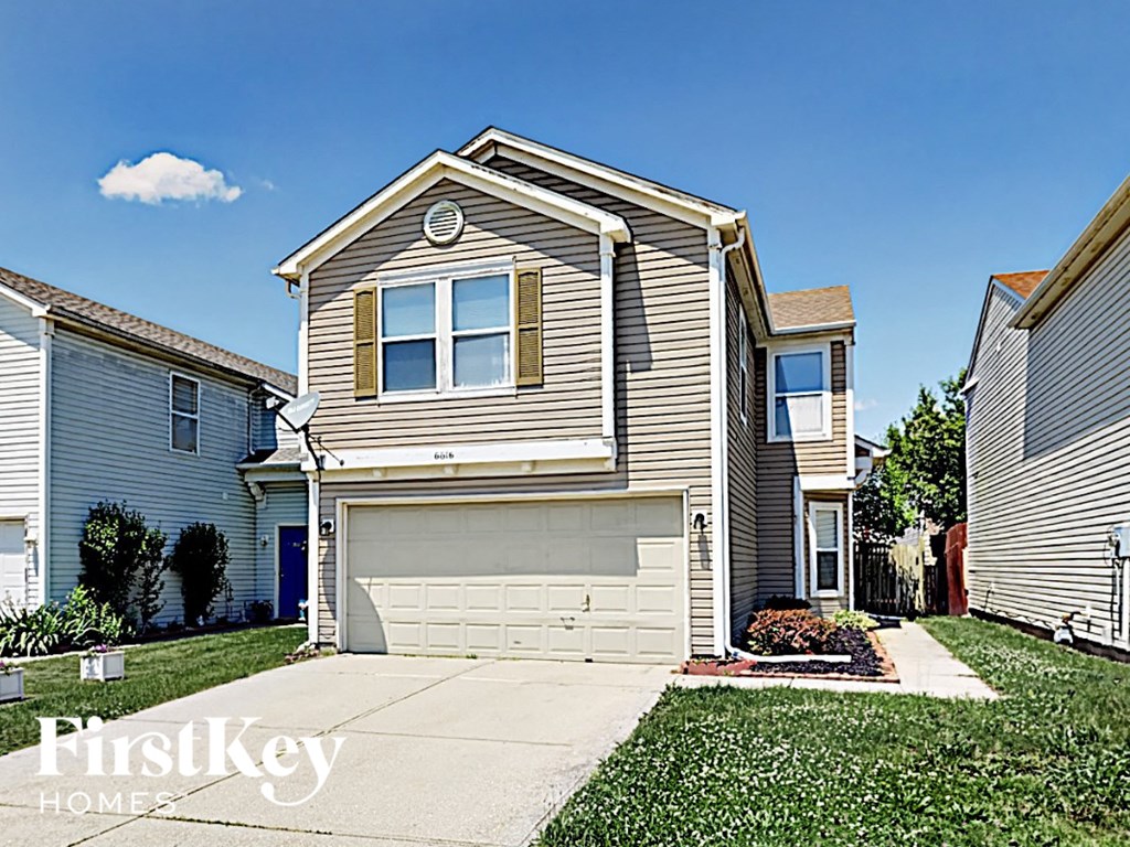 A house with a garage is for sale.