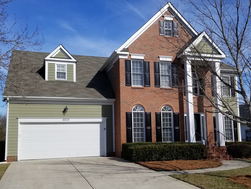 a large brick house with a white garage door