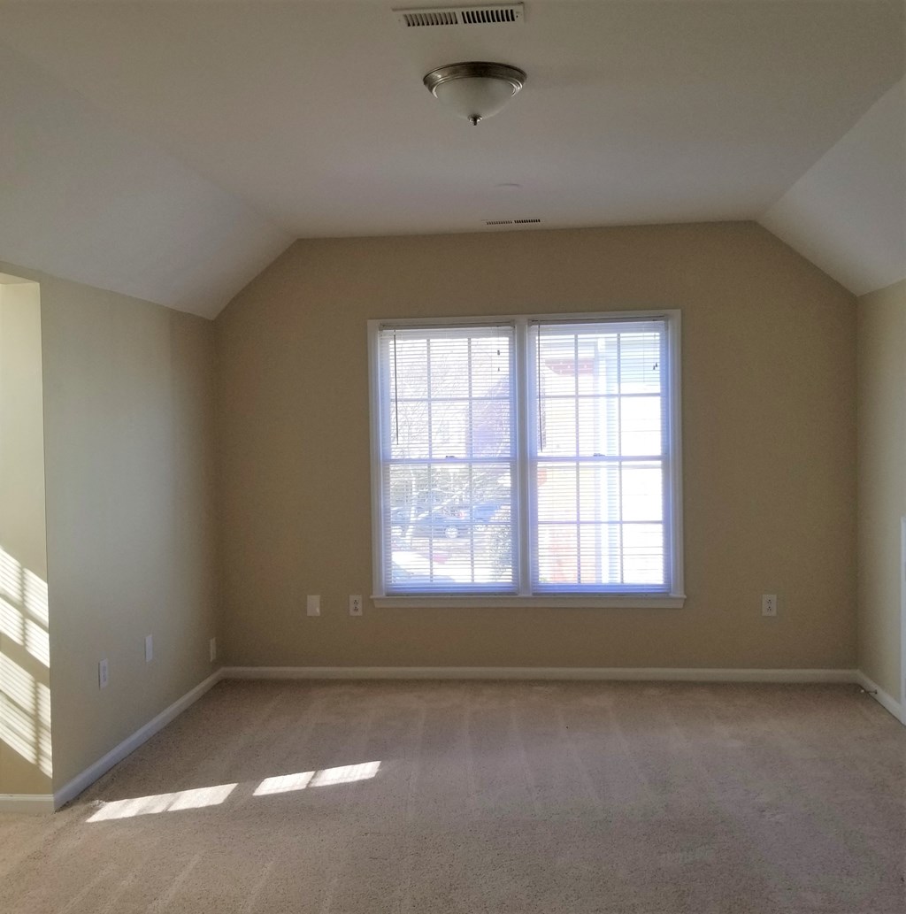 an empty living room with a large window