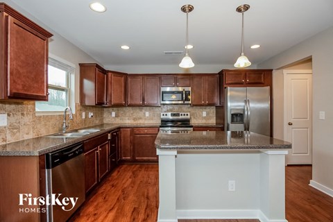 a kitchen with wooden cabinets and granite counter tops