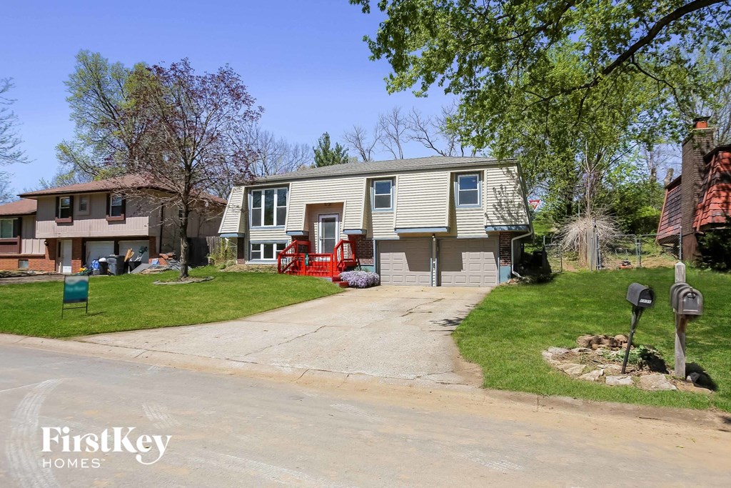 a house being remodeled in front of a yard with a yard excavator