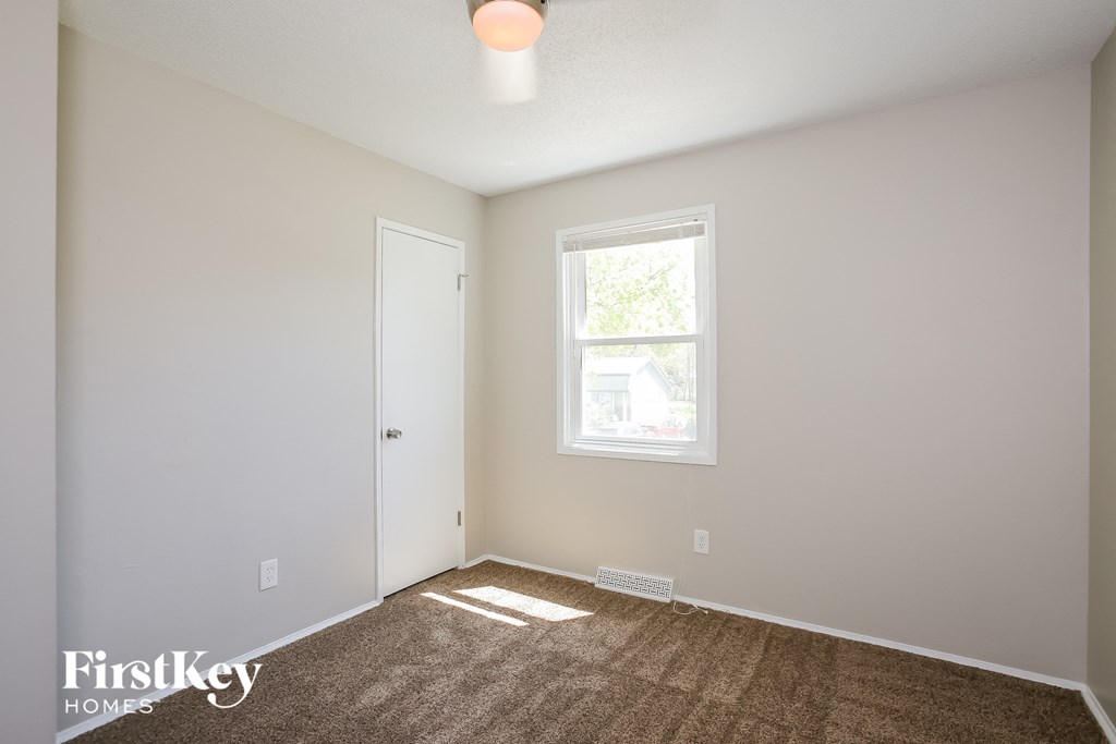 a room with a carpeted floor and a window