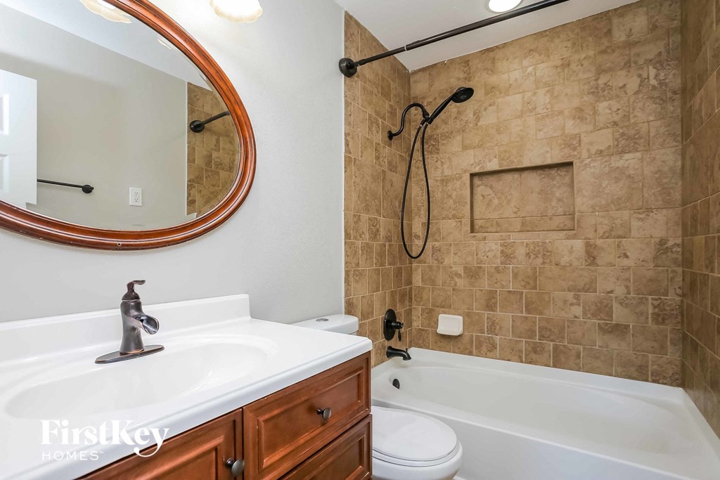 a bathroom with a sink and a shower and a toilet