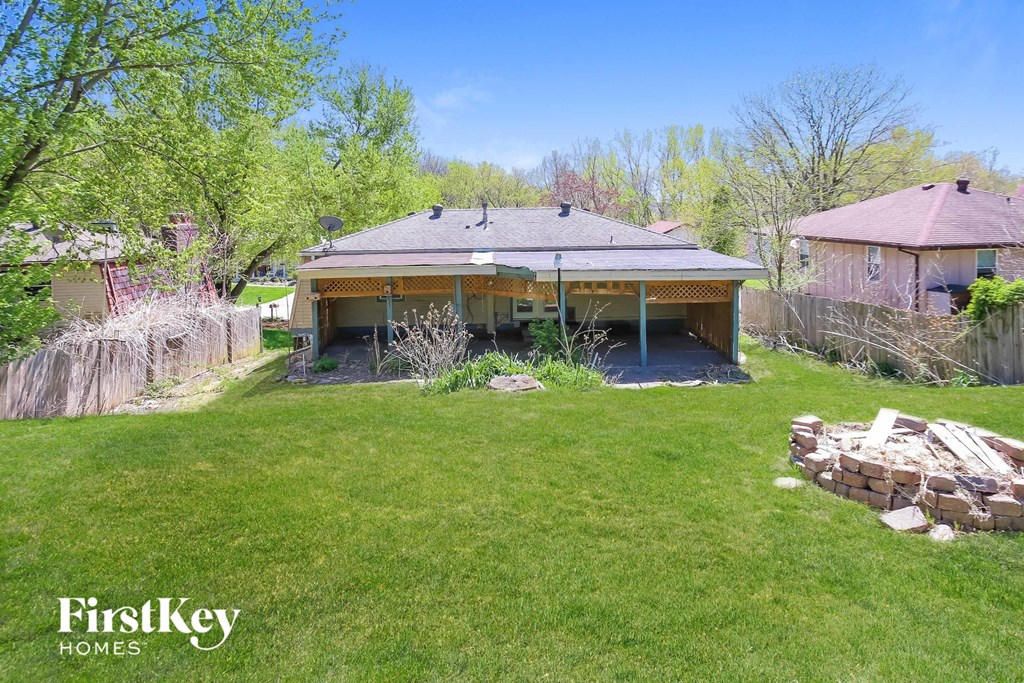 a backyard with a house and a yard with grass and trees