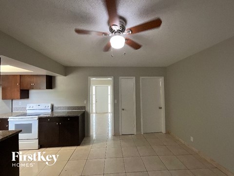 A kitchen with a fan and a stove top oven.