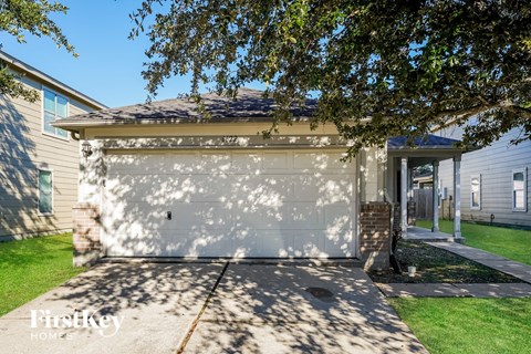 a white garage door in front of a house