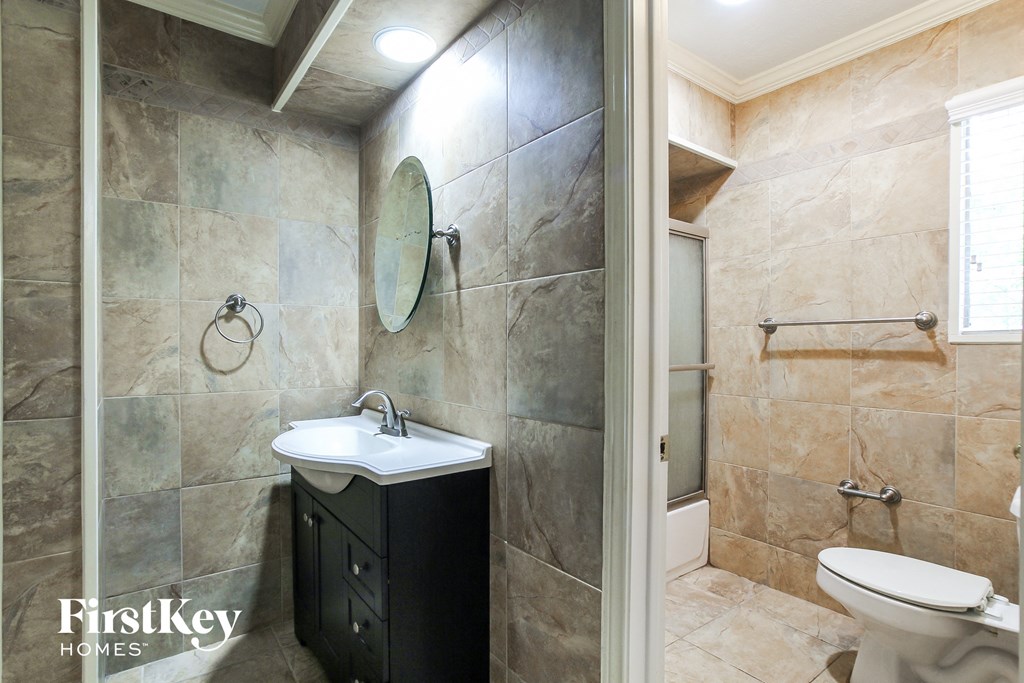 a small bathroom with a sink and toilet and a shower