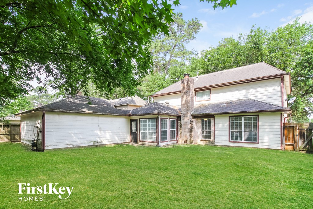 a white house with a yard and a wood fence