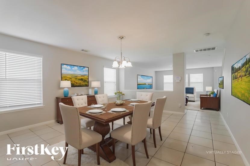 A dining room with a wooden table and chairs.