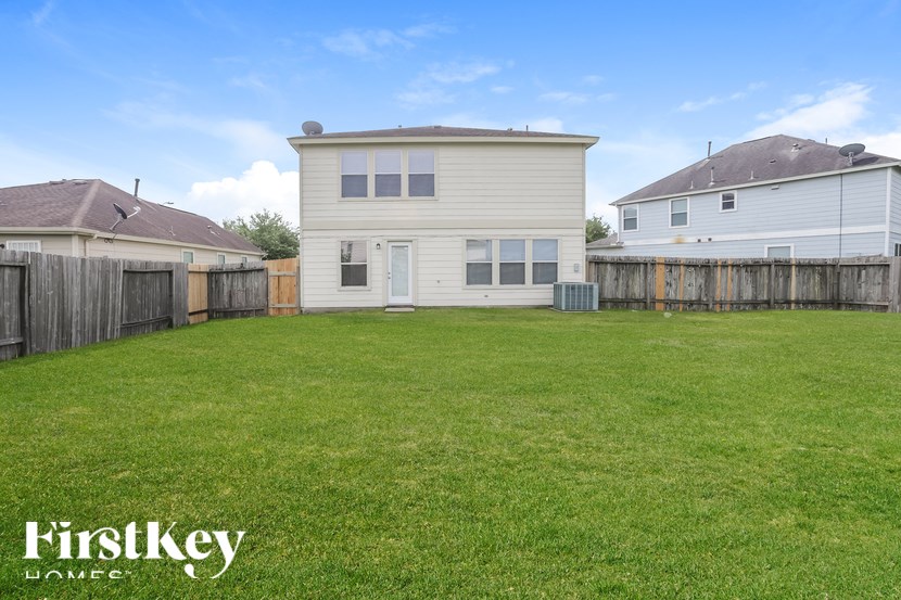 A house with a fence and a grassy yard.