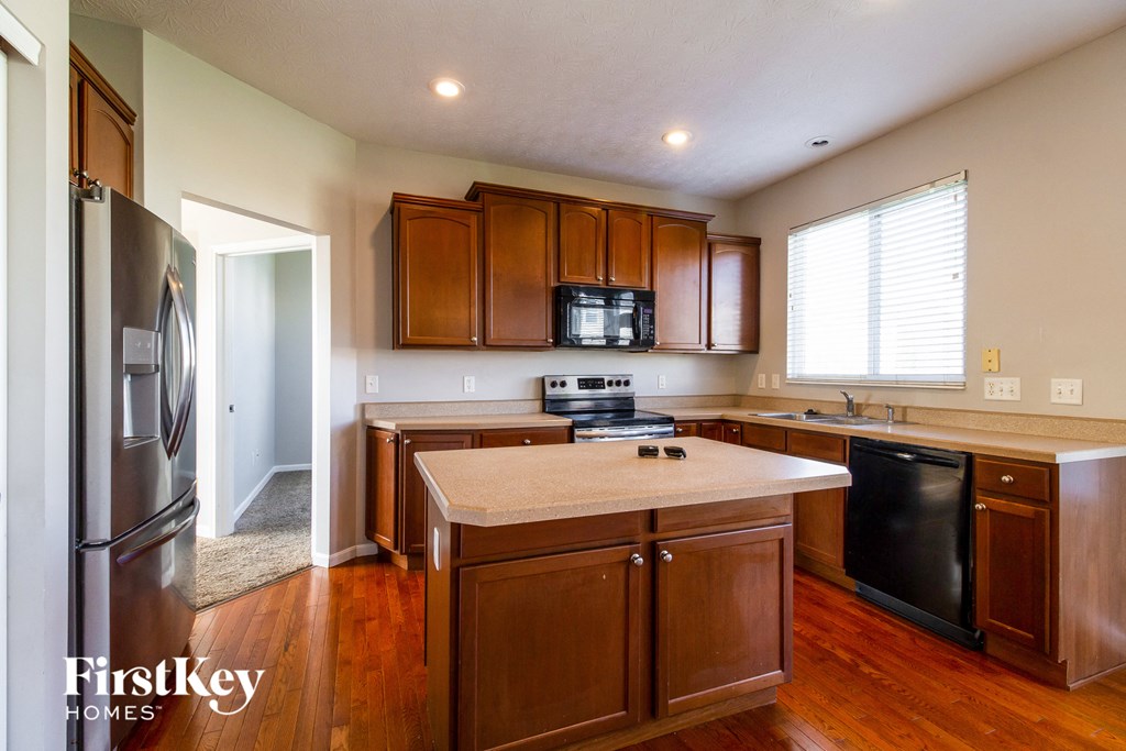 a kitchen with wooden cabinets and stainless steel appliances