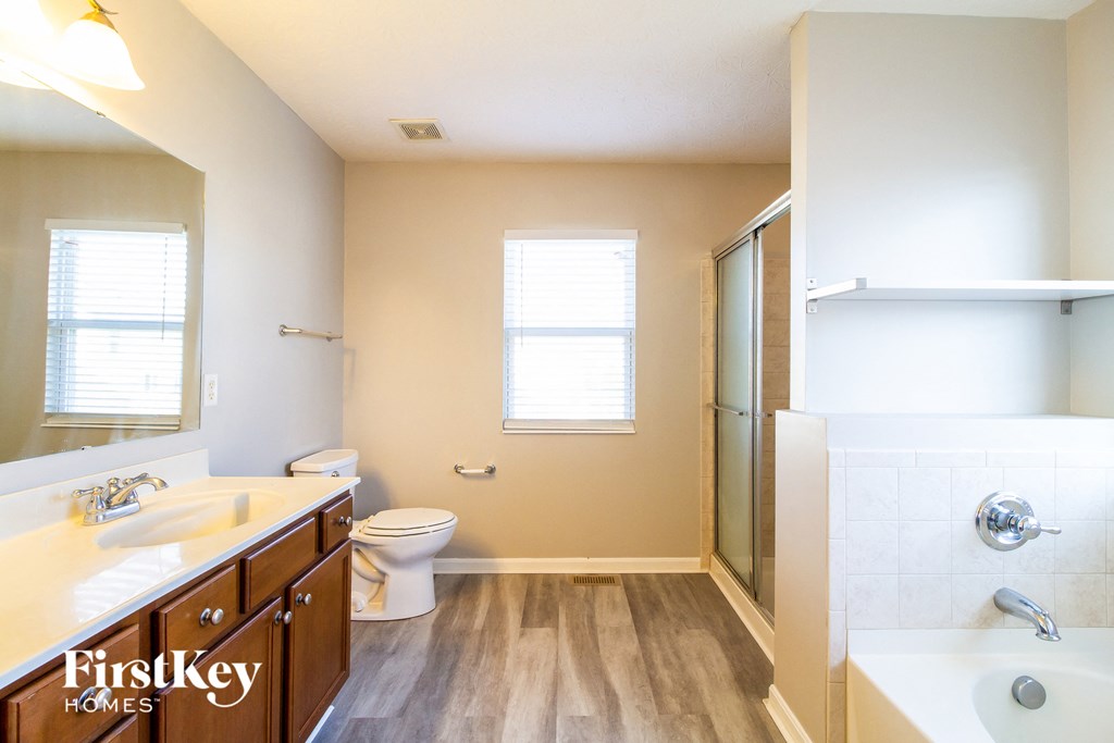 a bathroom with a toilet and a sink and a shower