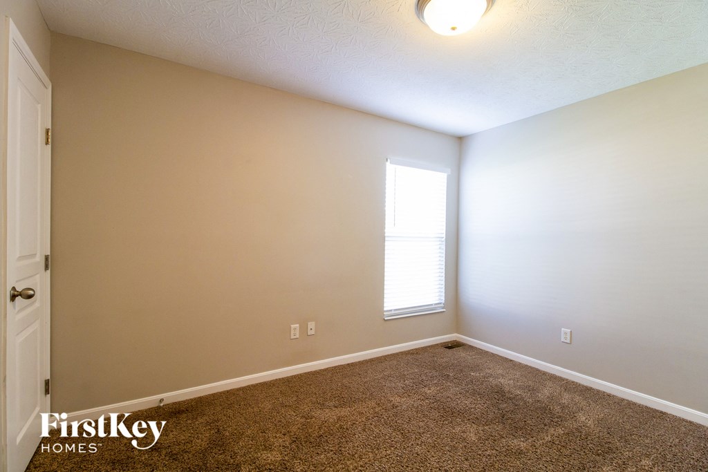 a room with a carpeted floor and a window
