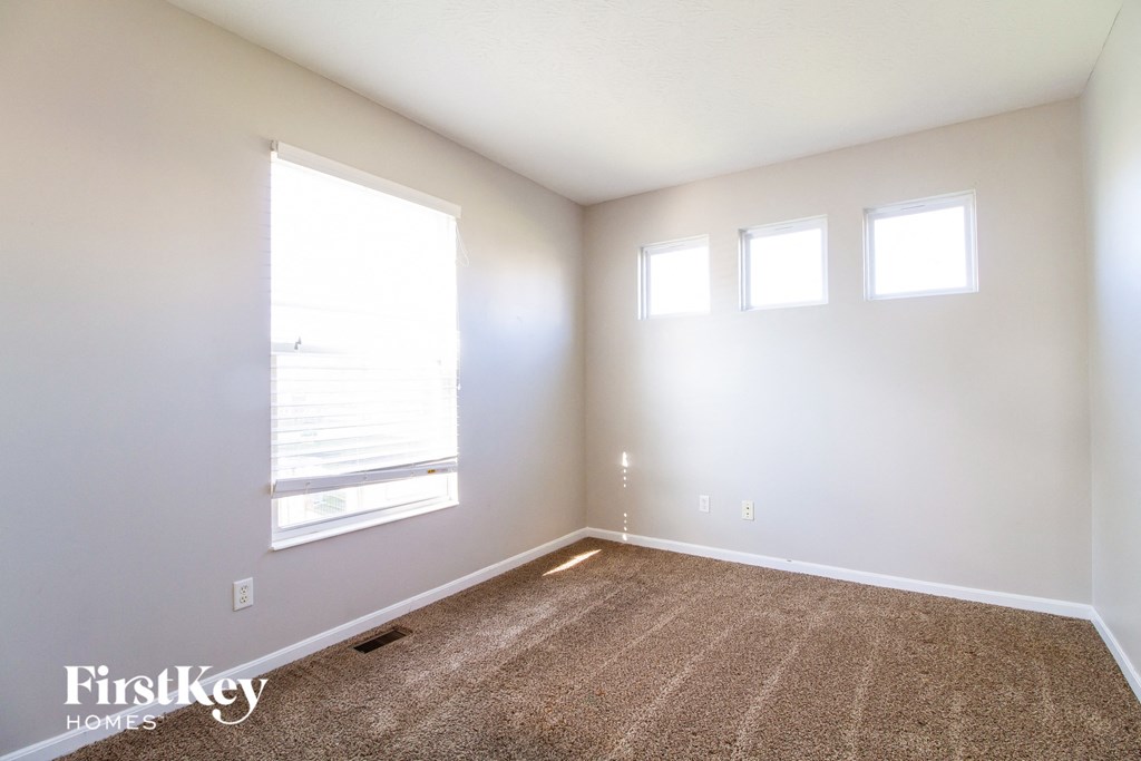 a empty room with a window and carpet