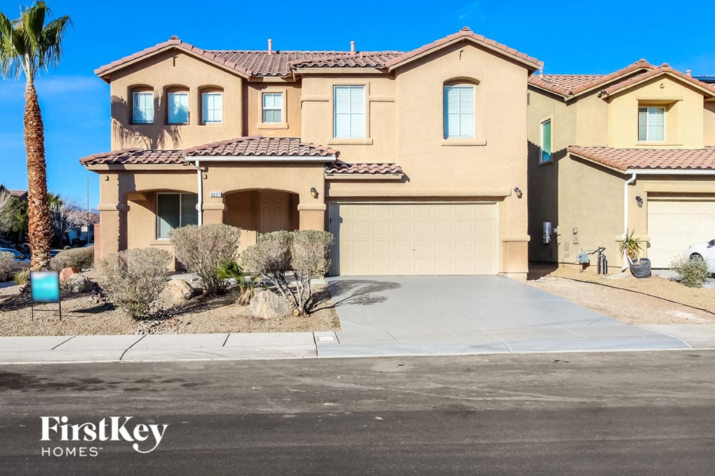 A large house with a driveway in front of it.