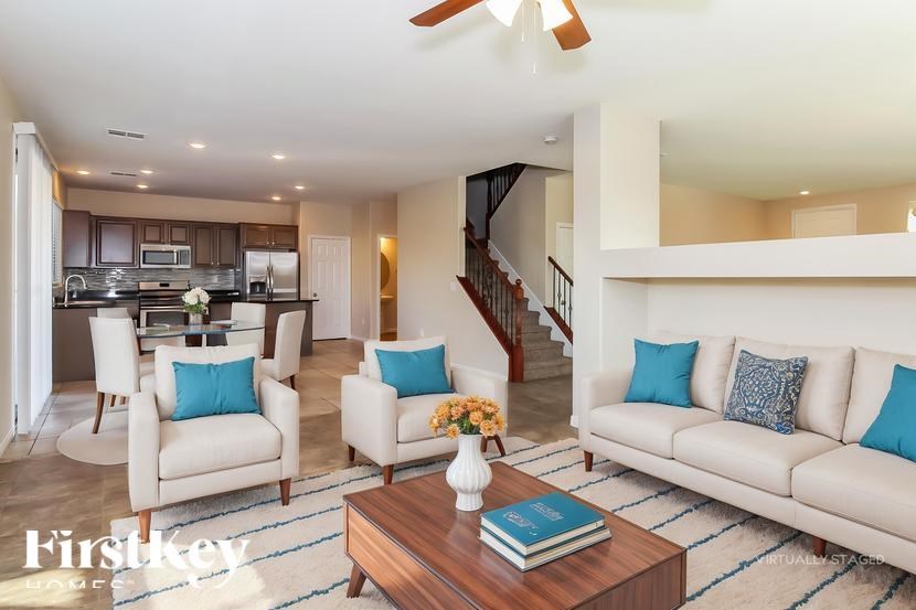 A living room with a couch, chairs, and a coffee table.