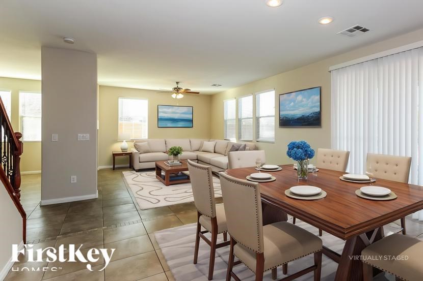 A dining room with a wooden table and chairs.