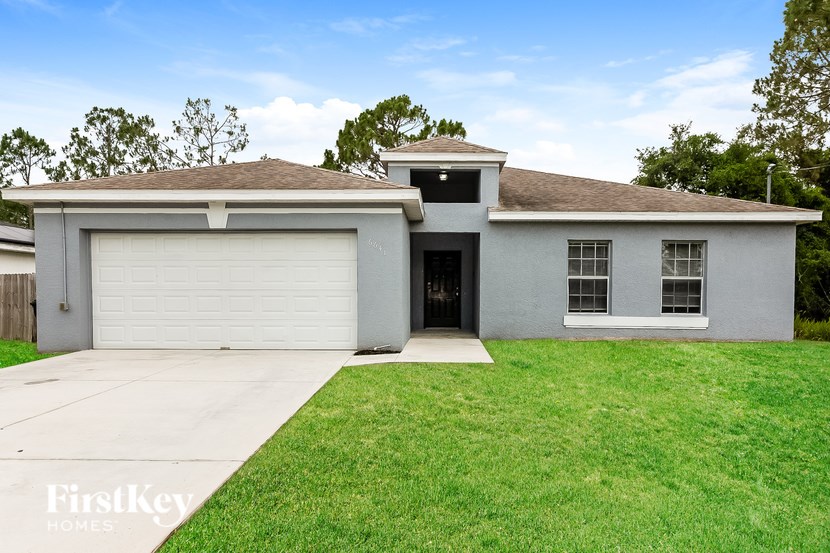 A house with a garage door and a driveway.