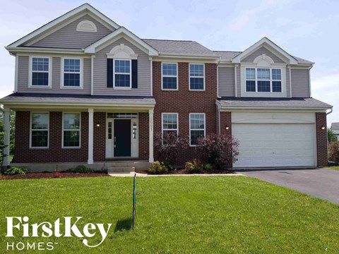 A house with a garage and a sign that says FirstKey Homes.