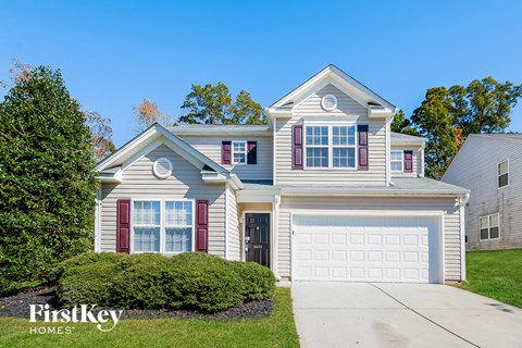 a home with a white garage door and a blue house