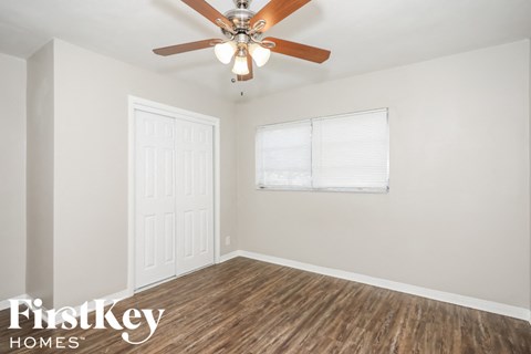 a living room with a ceiling fan and a window