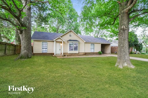 the front of a house with two trees