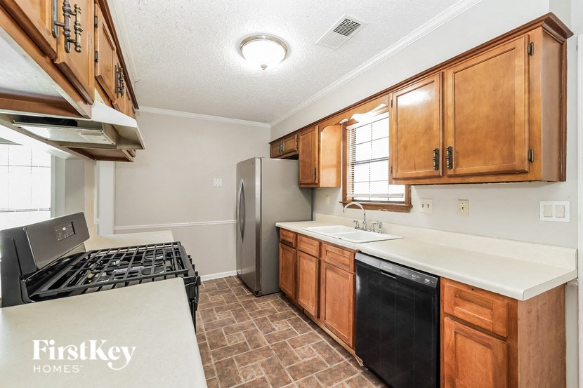a kitchen with a stove refrigerator and sink