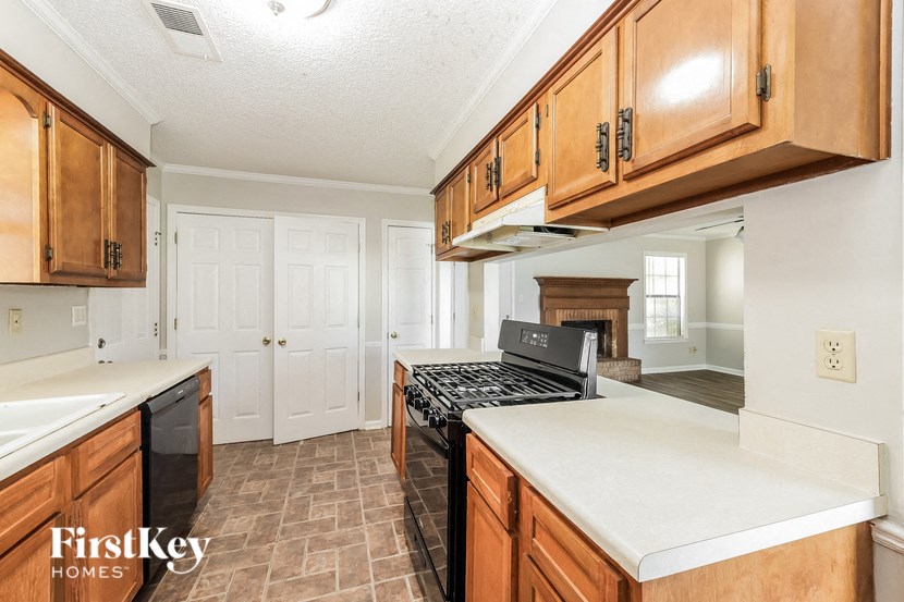 a kitchen with wooden cabinets and a stove top oven