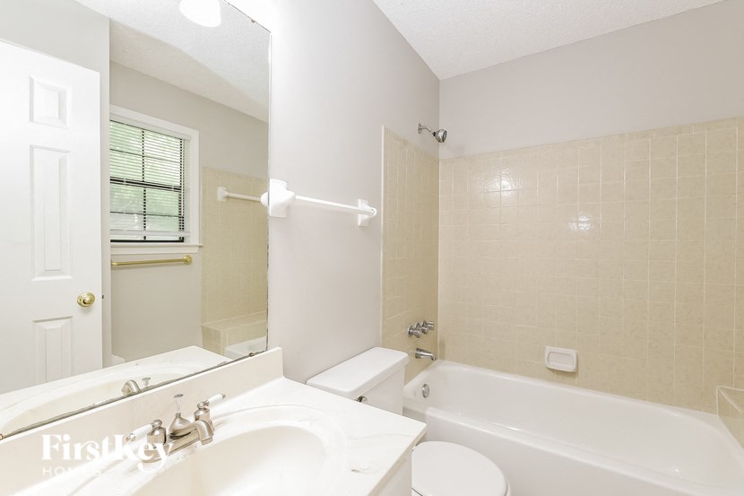 a bathroom with a sink toilet and a bath tub