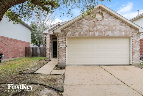 a white brick house with a white garage door