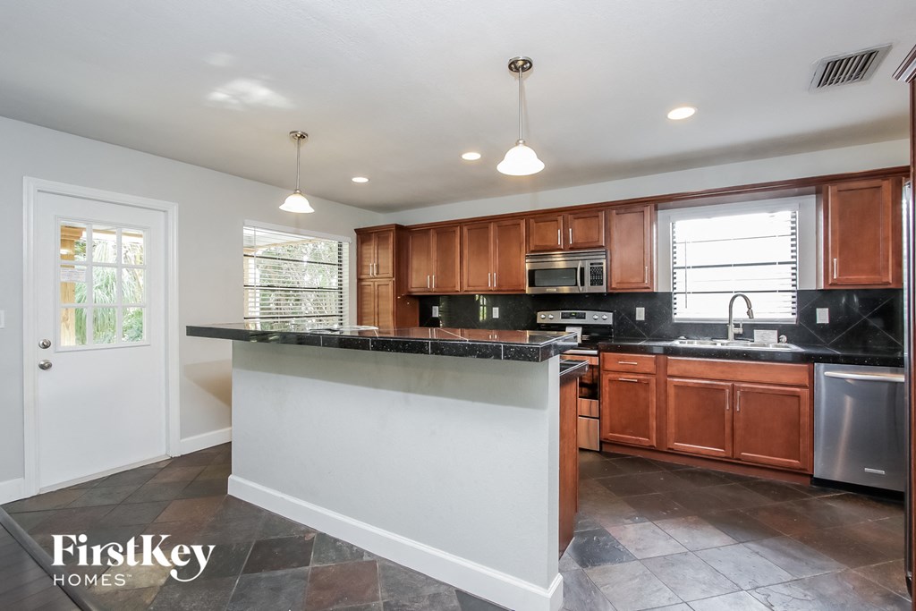 a kitchen with wooden cabinets and a counter top