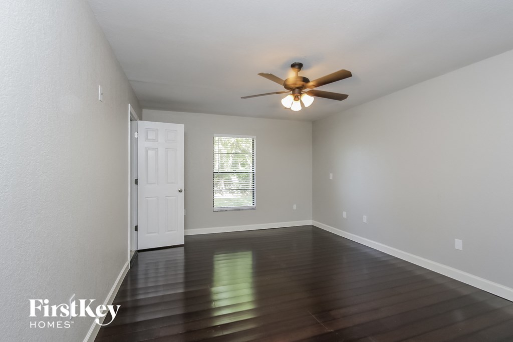 a living room with hardwood floors and a ceiling fan