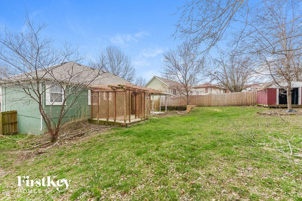 the backyard of a house with a fence and a yard with a gated backyard