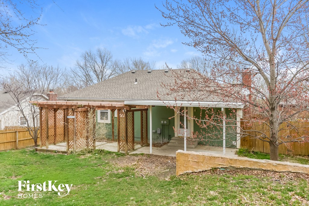 the front of a house with wood framing and a porch