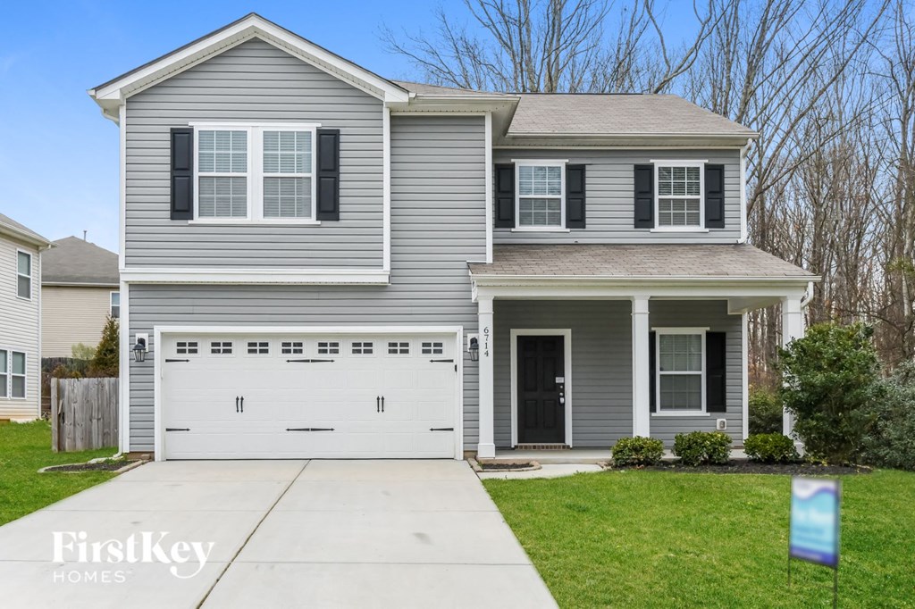 a gray house with a white garage door