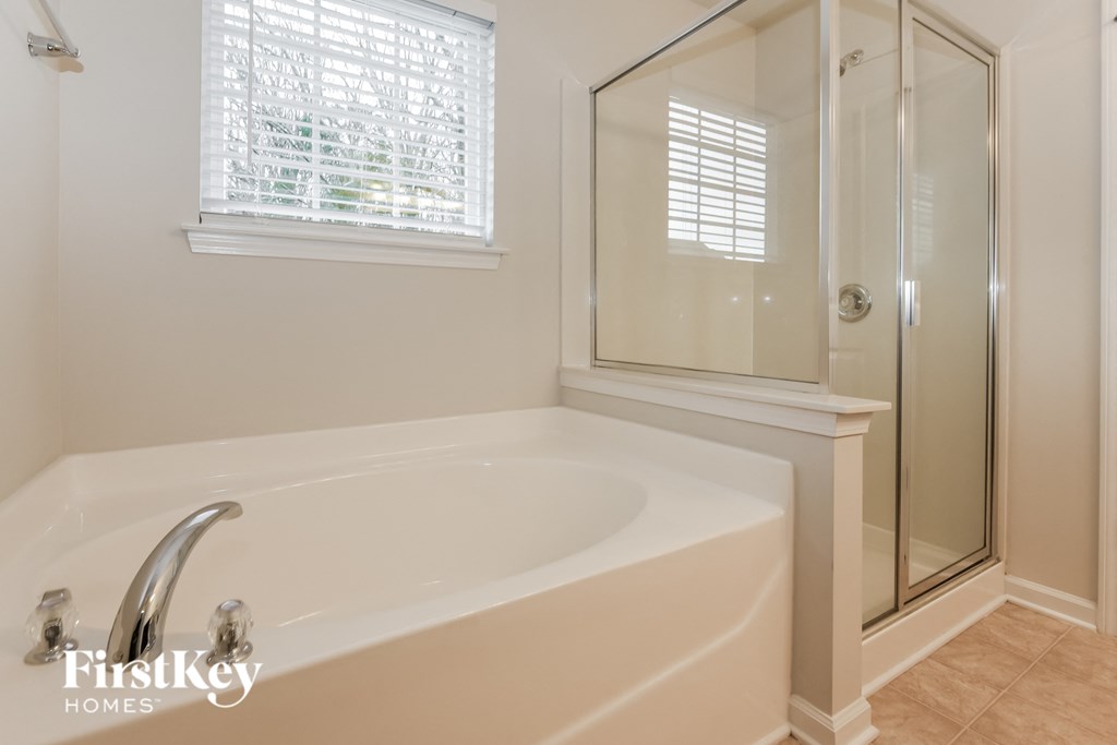 a bathroom with a large tub and a shower