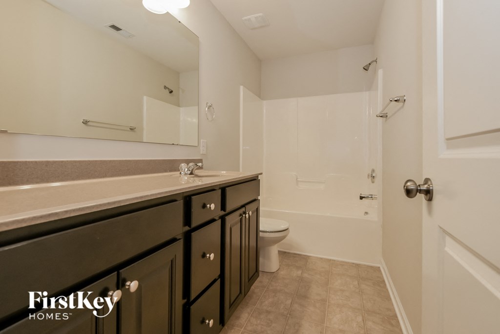a bathroom with a sink and a toilet and a shower