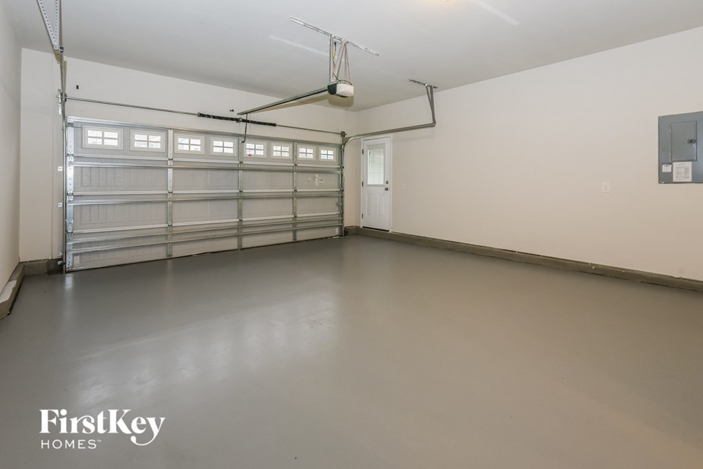 the inside of a garage with white walls and garage doors