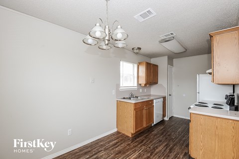 A kitchen with wooden cabinets and a white countertop.