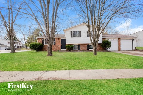 A house with a lawn in front of it.