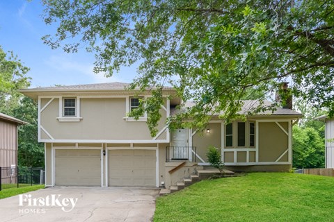 A two-story house with a garage is for sale.