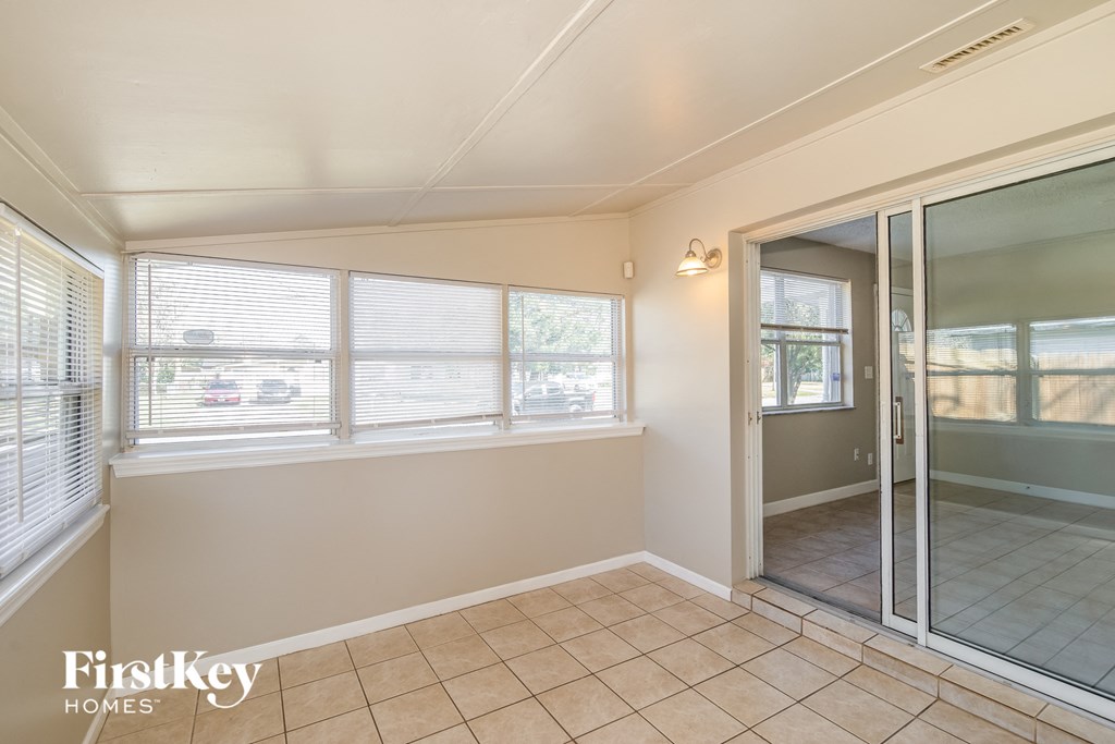 a room with a large window and a sliding glass door
