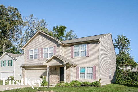 A two-story house with a garage is for sale.