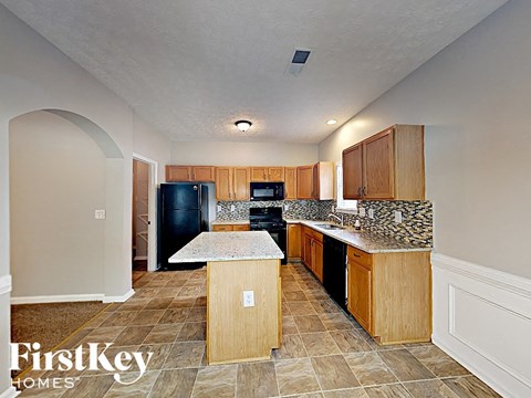 A kitchen with wooden cabinets and a granite countertop.