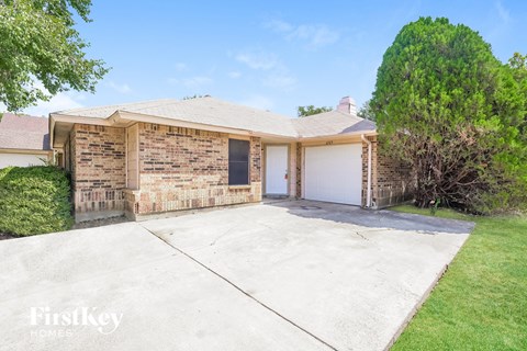 a brick house with a driveway and a garage door