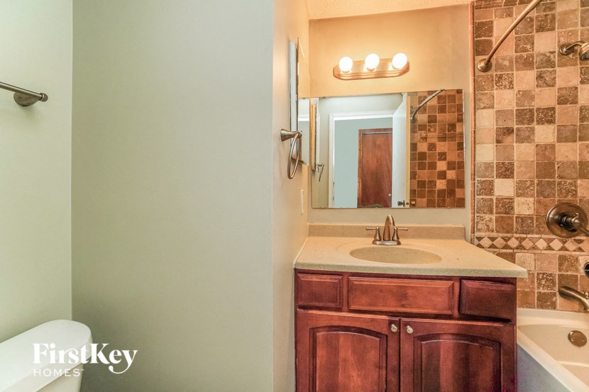 a full view of a bathroom with a sink and a mirror